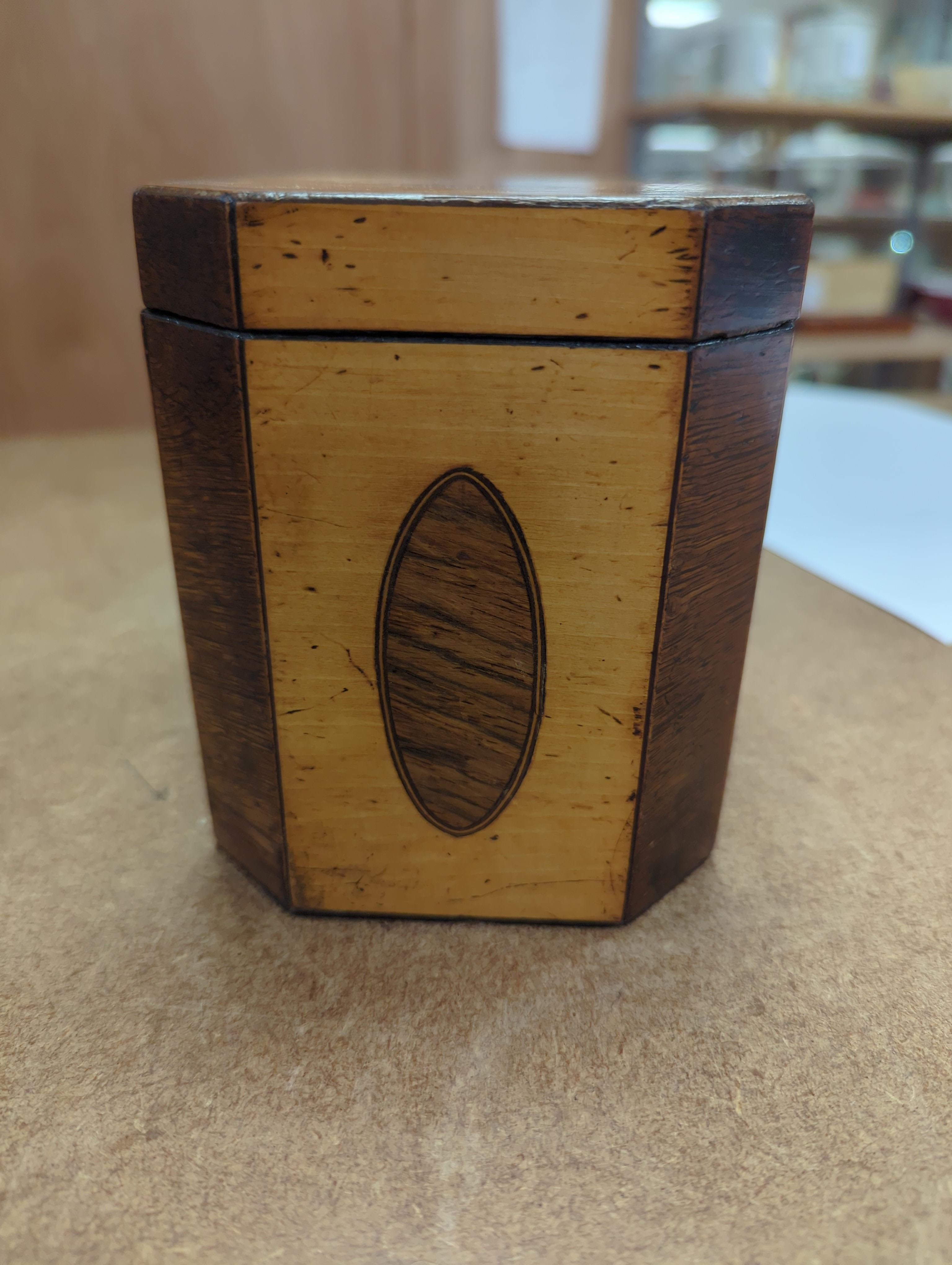 A George III sycamore and rosewood octagonal tea caddy, 13cm